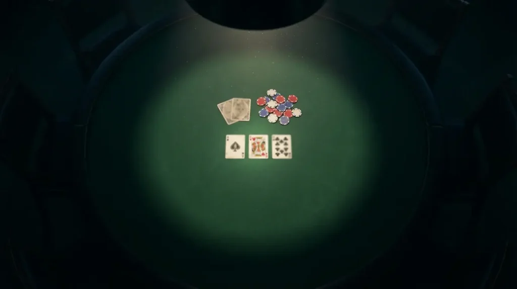 Poker cards and chips on a dark green table with dramatic overhead lighting